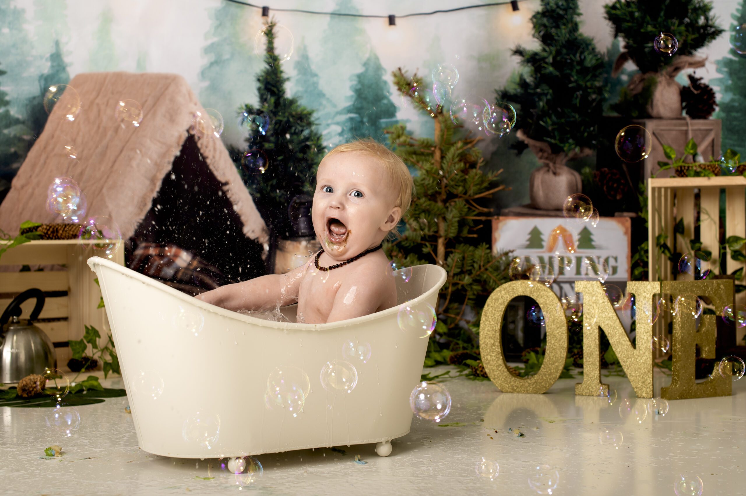 little boy sitting in a bathtub for his photoshoot