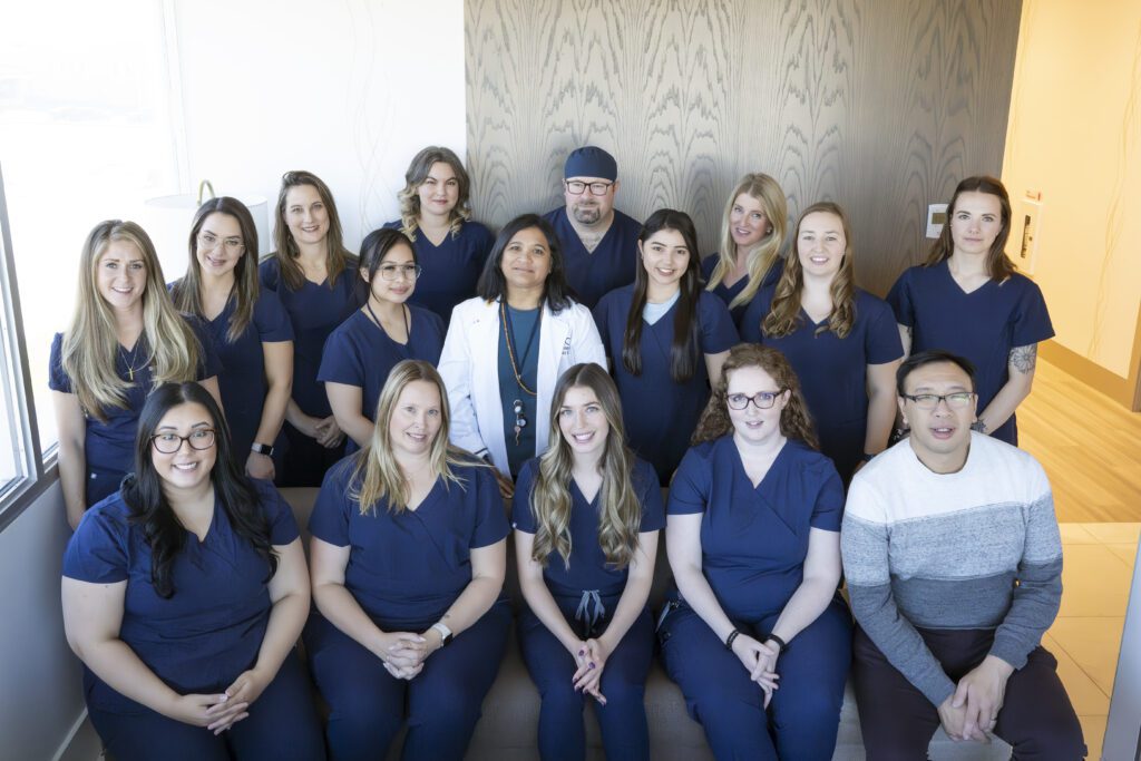 A staff photo from the Alberta Reproductive Centre with everyone wearing navy scrubs